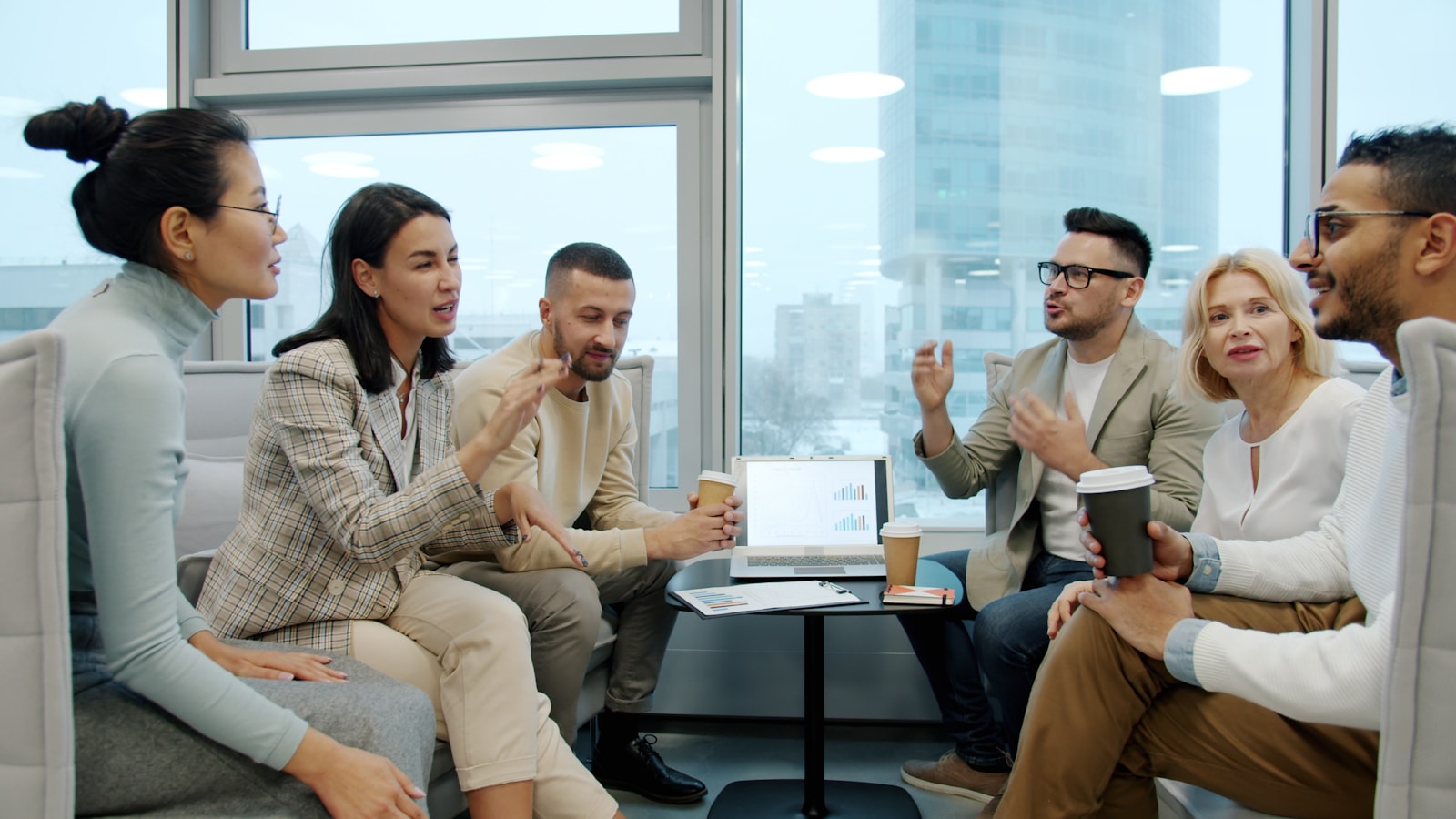 Diverse colleagues in discussion at a modern office table.